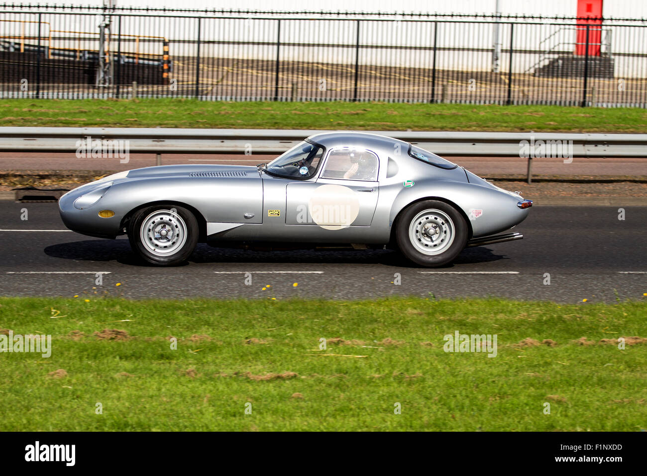 Panning a classic Silver 1960`s EType Jaguar sports car travelling
